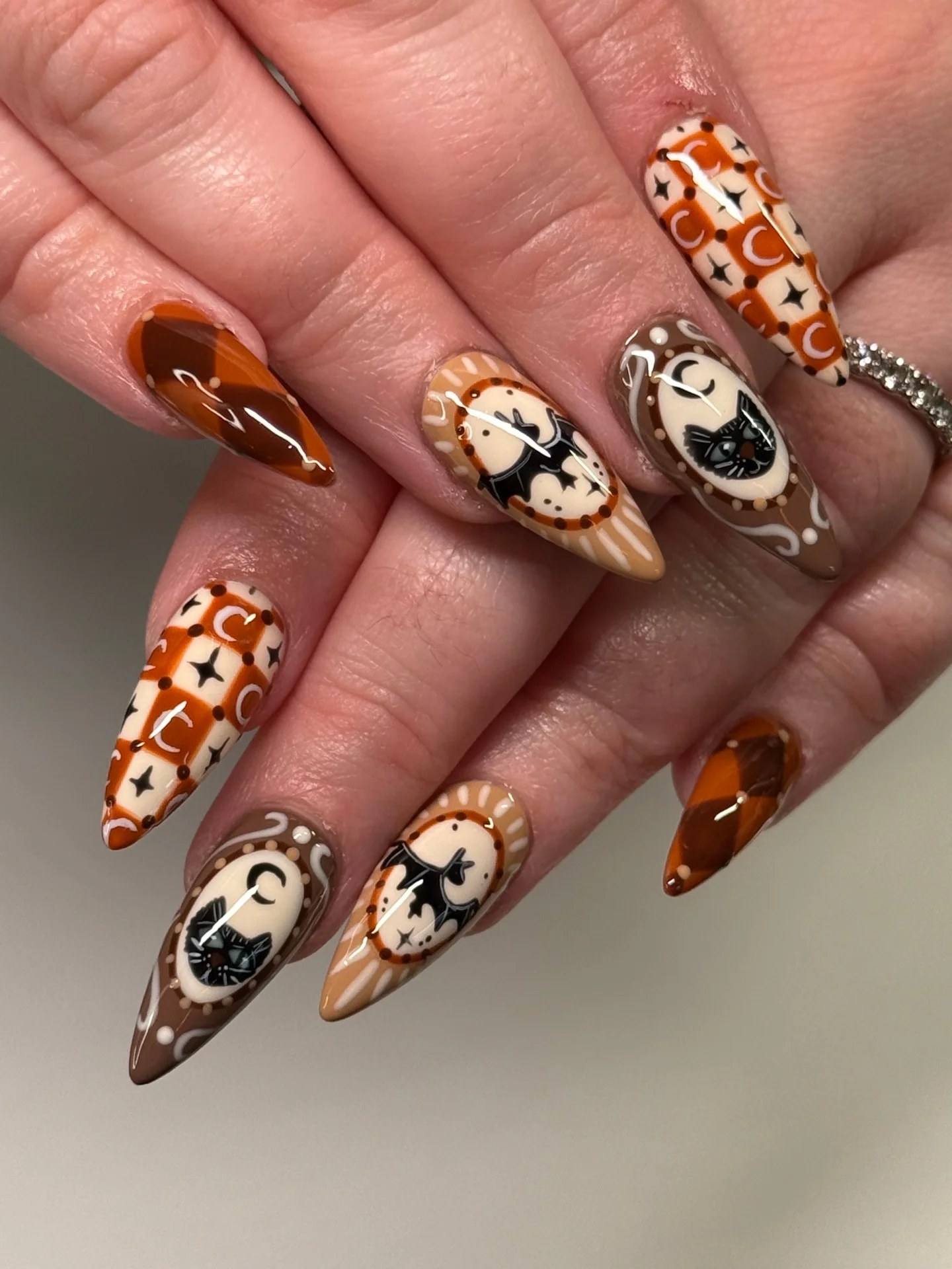 halloween nail art 2026 Vintage Brown Cat And Bat Almond Nails