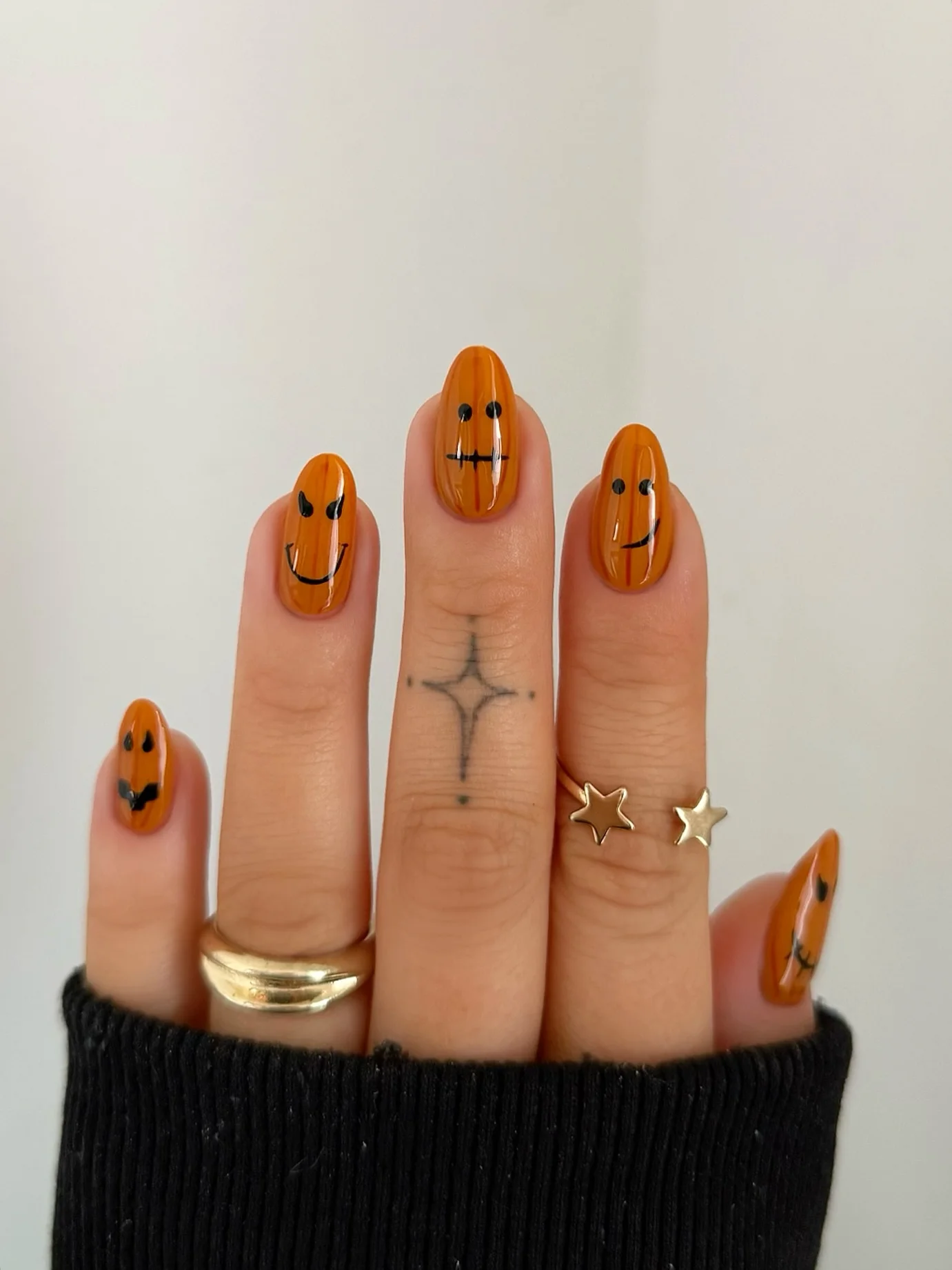 halloween nails designs 2026 Glossy Pumpkin Faces In Warm Amber Orange