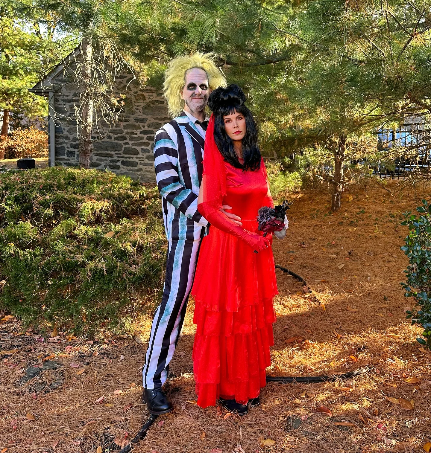 trendy halloween outfits 2026 Beetlejuice-Inspired Couple In Red And Stripes