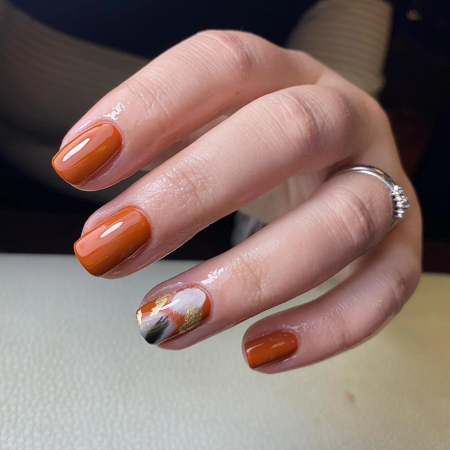 fall accent nail designs 2026 Burnt Orange Nails With A Metallic Abstract Accent