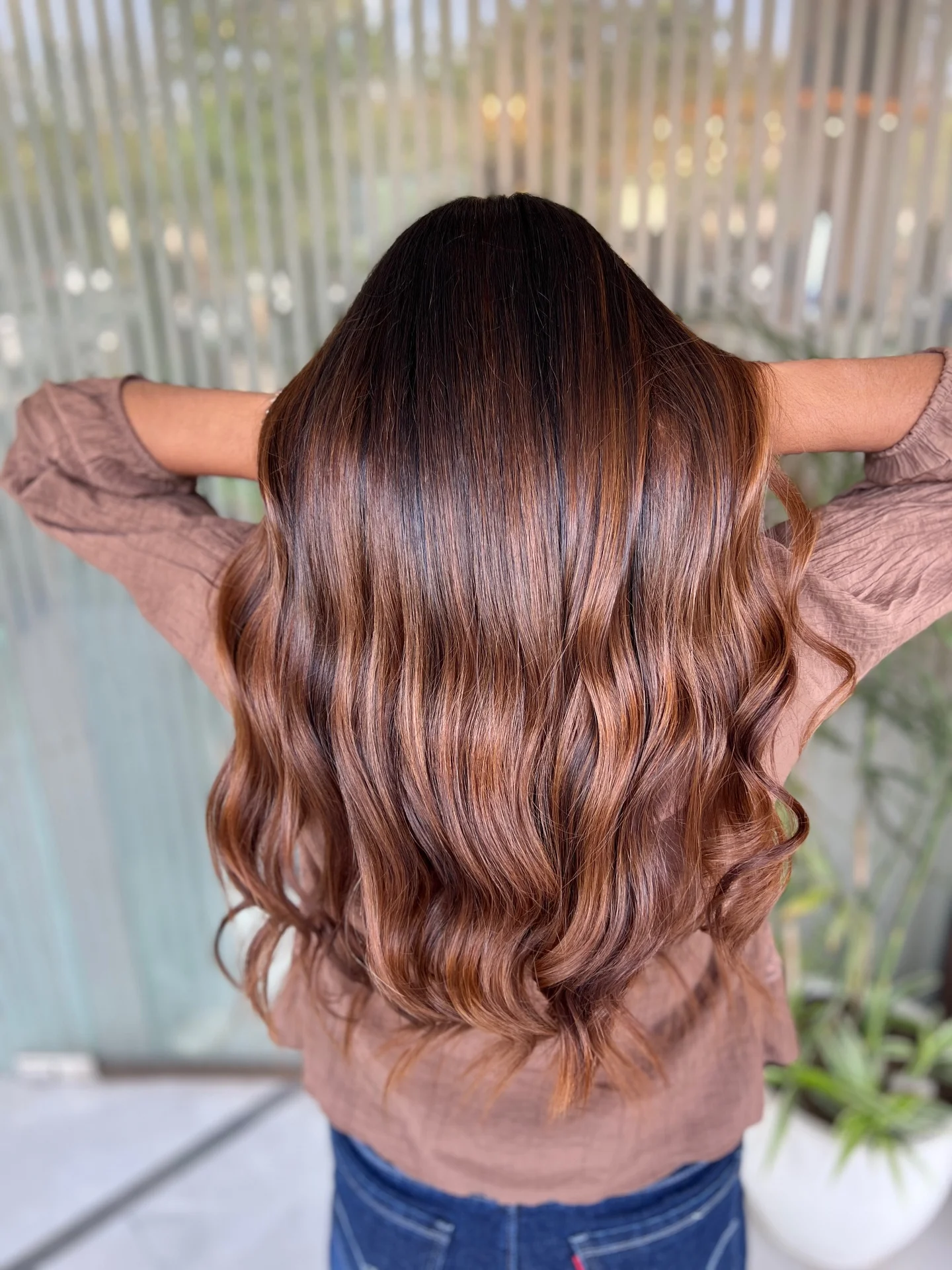 fall brown hair color ideas 2026 Warm Cinnamon Brown Balayage With Glossy Length