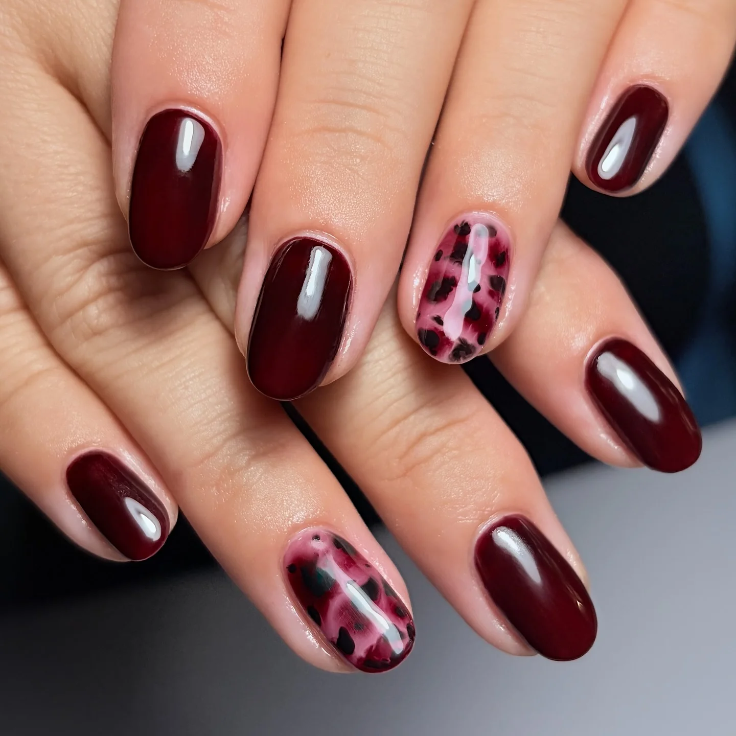fall trendy nails 2026 Glossy Wine Nails With Moody Abstract Animal Accents