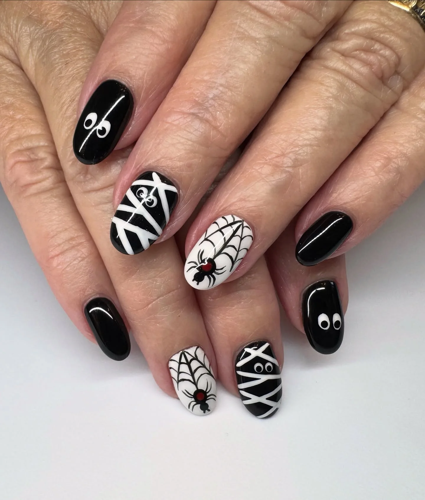 halloween nails designs 2026 Black And White Mummy Nails With Spider Web Accents