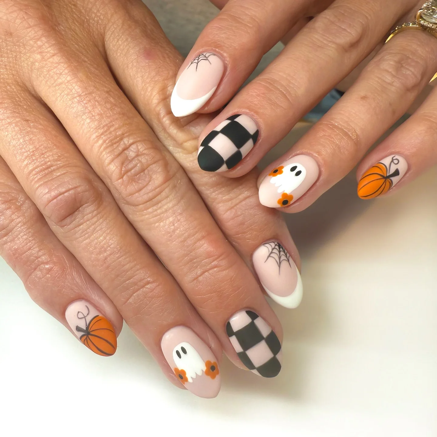 halloween nails designs 2026 Soft Ghosts And Pumpkin Details With Checkerboard Tips