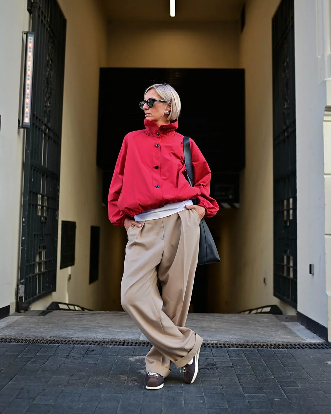 september fashion colors Bright Red Jacket With Relaxed Beige Trousers