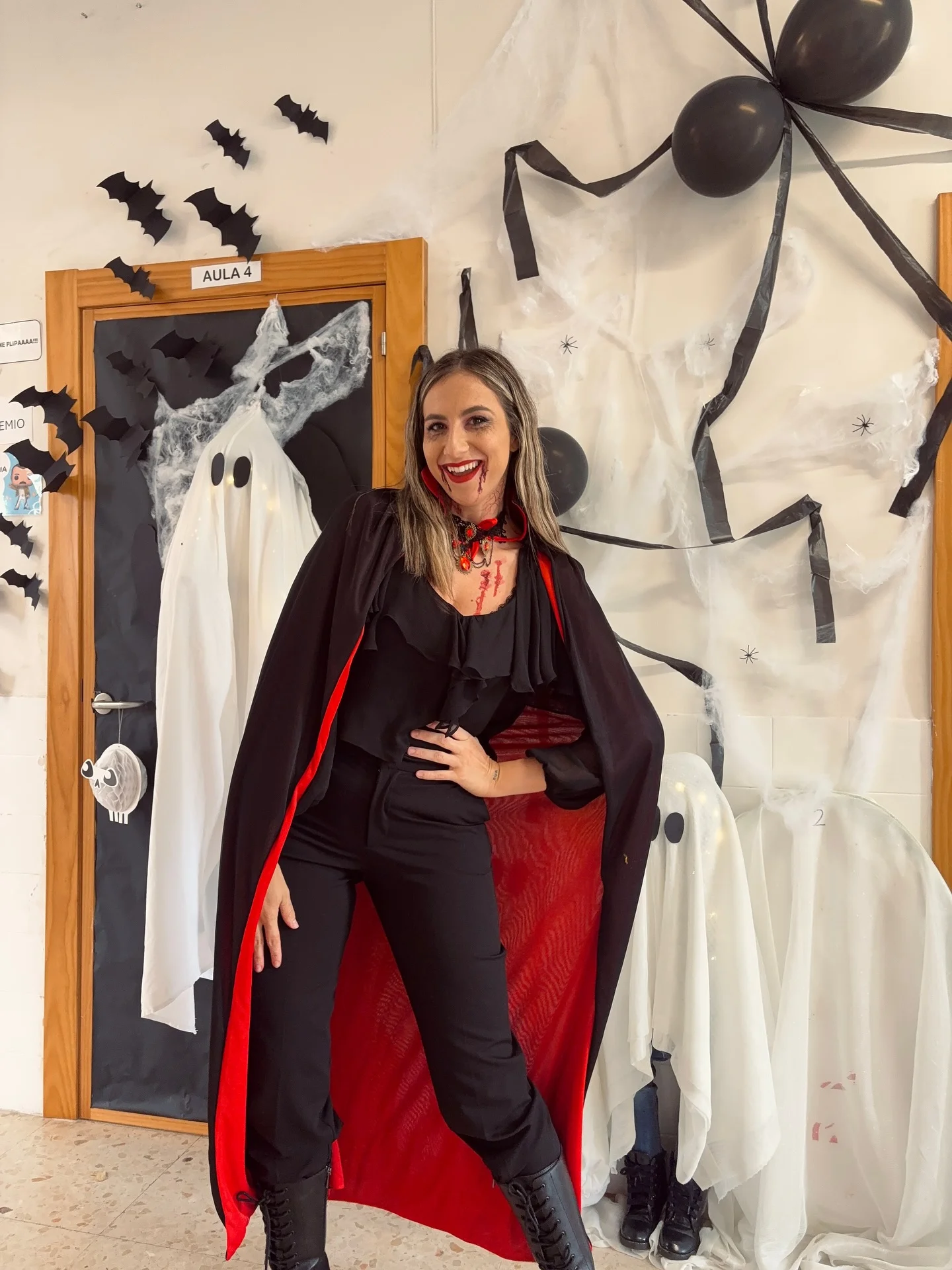 trendy halloween outfits 2026 Elegant Vampire In A Black And Red Cape