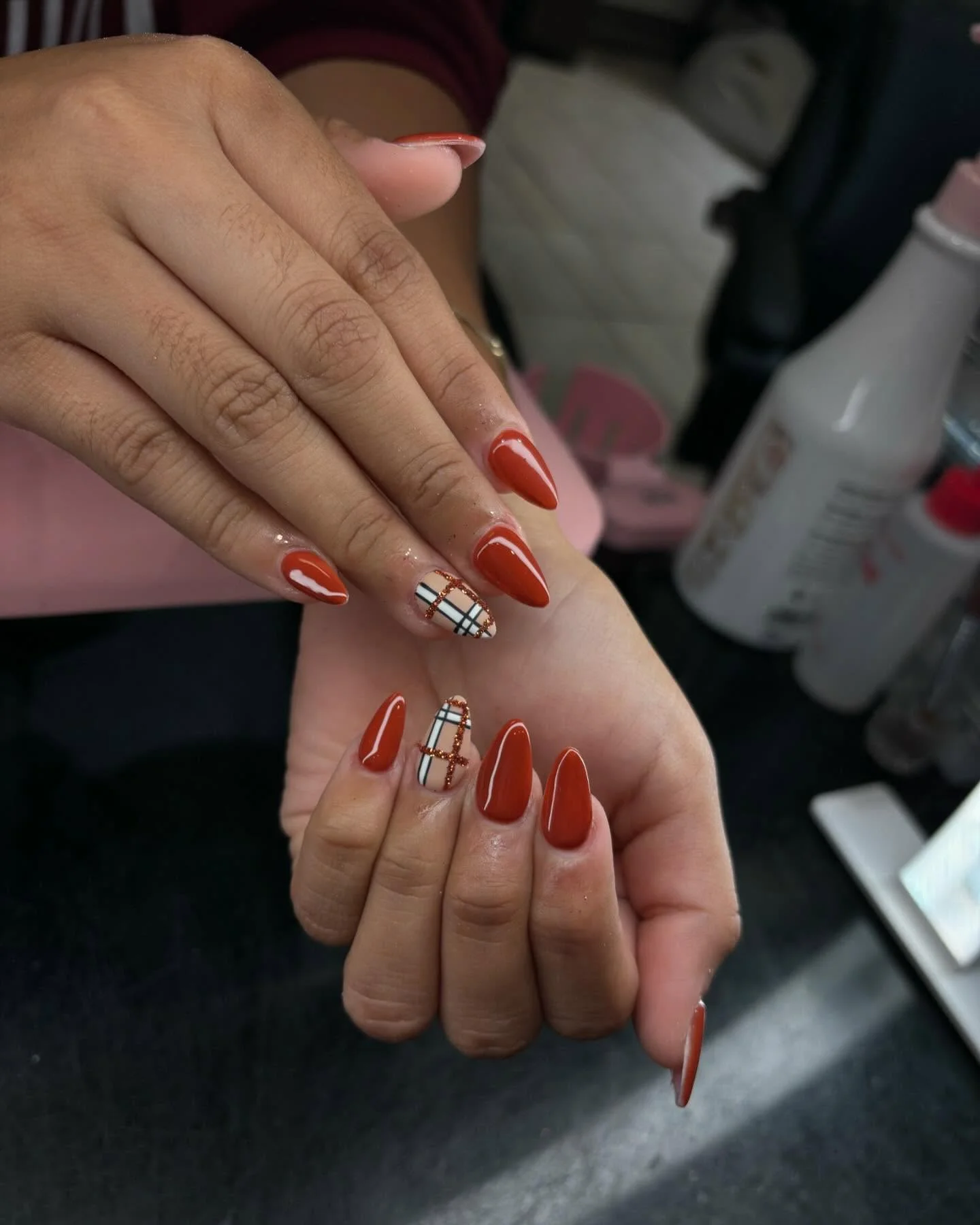 fall accent nail designs 2026 Rust Red Almond Nails With Classic Plaid Accent Details