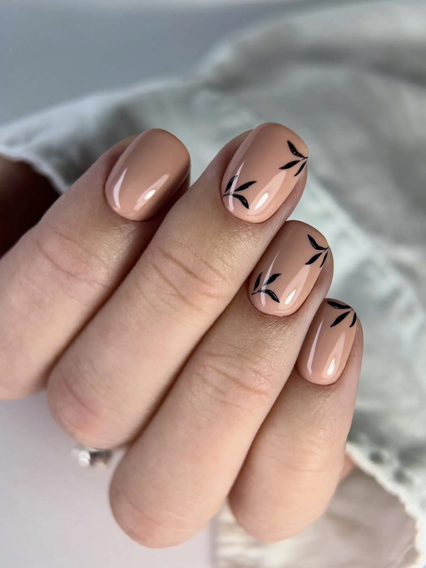 fall nails for fair skin tones 2026 Minimal Nude Nails With Tiny Black Leaf Motifs