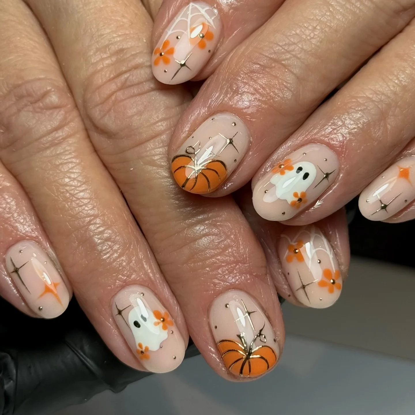 halloween nail art 2026 Soft Pumpkin And Ghost Nail Art With Metallic Details