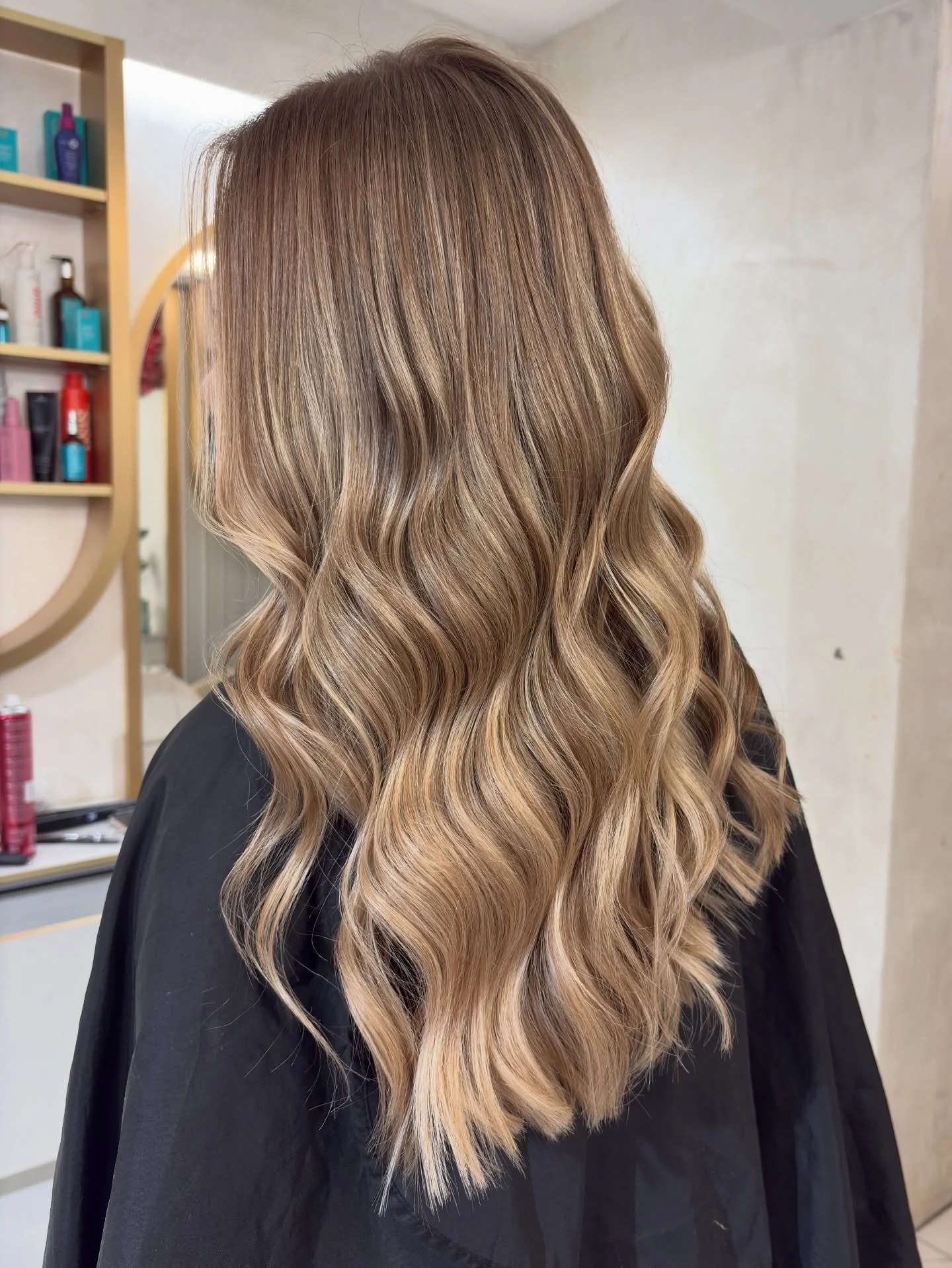 september hair color trends 2026 Warm Bronde Waves With Honey-Blonde Dimension