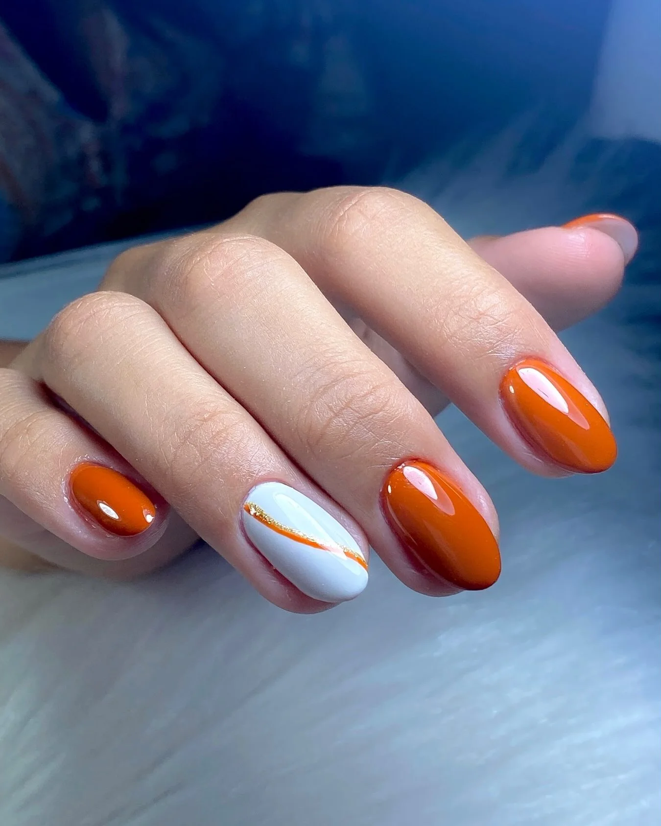 fall accent nail designs 2026 Bright Orange Nails With A White And Gold Accent