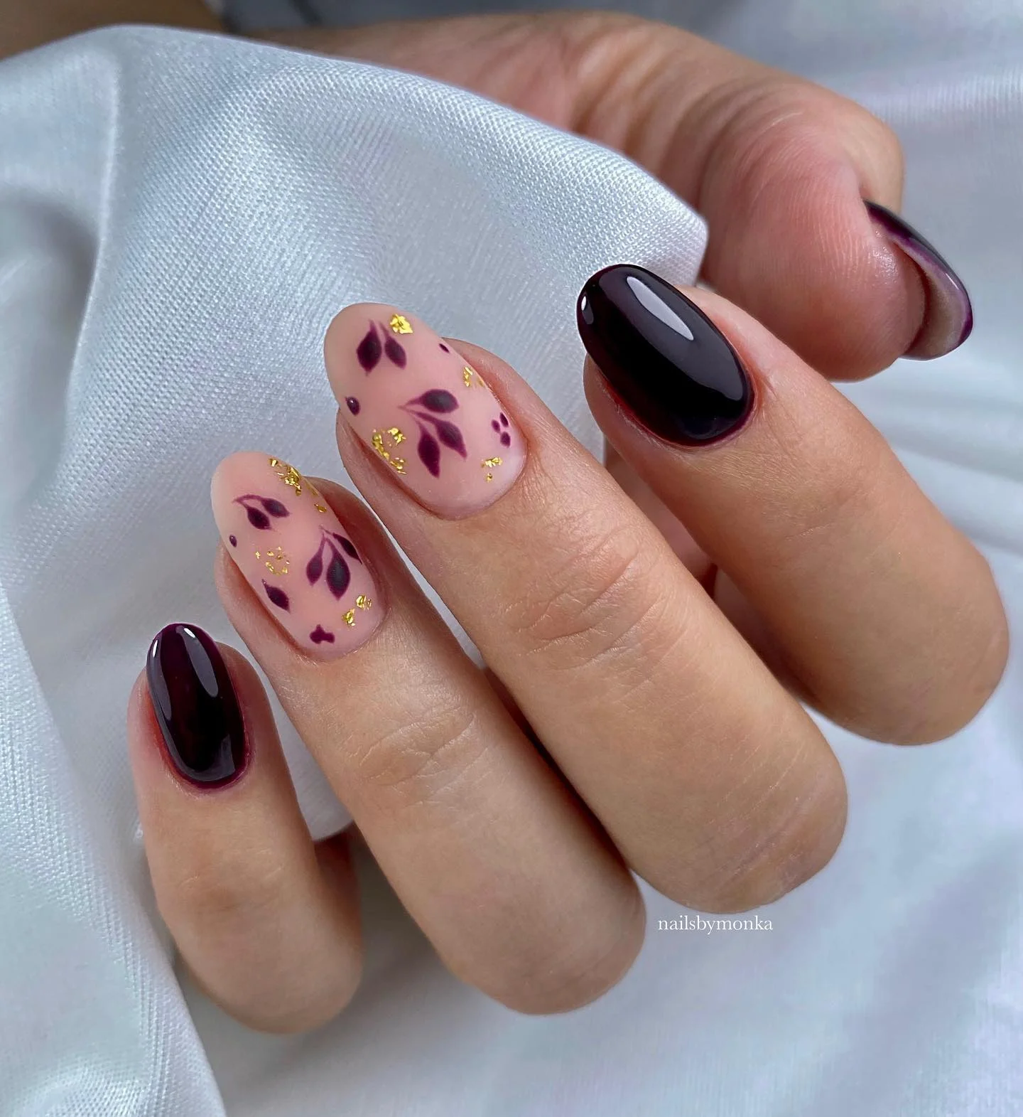 fall nails for pale skin 2026 Glossy Plum With Botanical Gold Leaf Details
