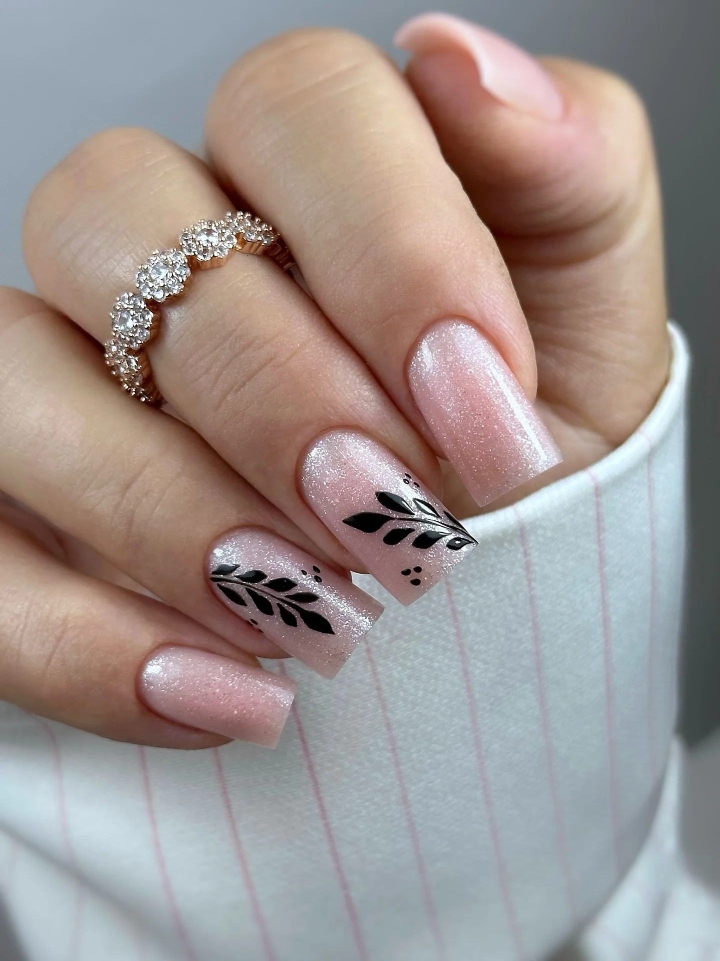 fall trendy nails 2026 Shimmering Blush Nails With Black Botanical Silhouettes
