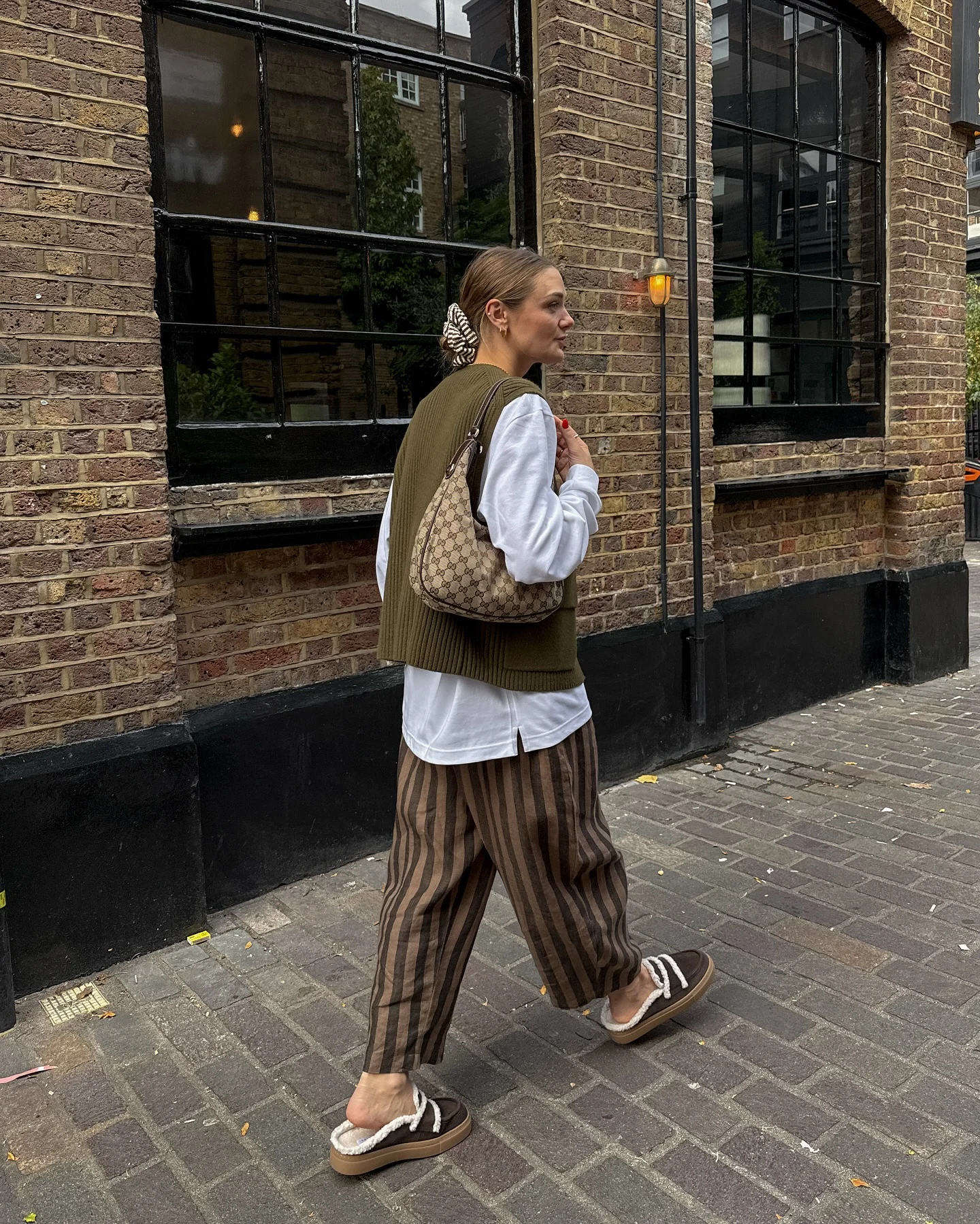 september fashion trends Olive Knit Vest With Striped Trousers And Relaxed Layers