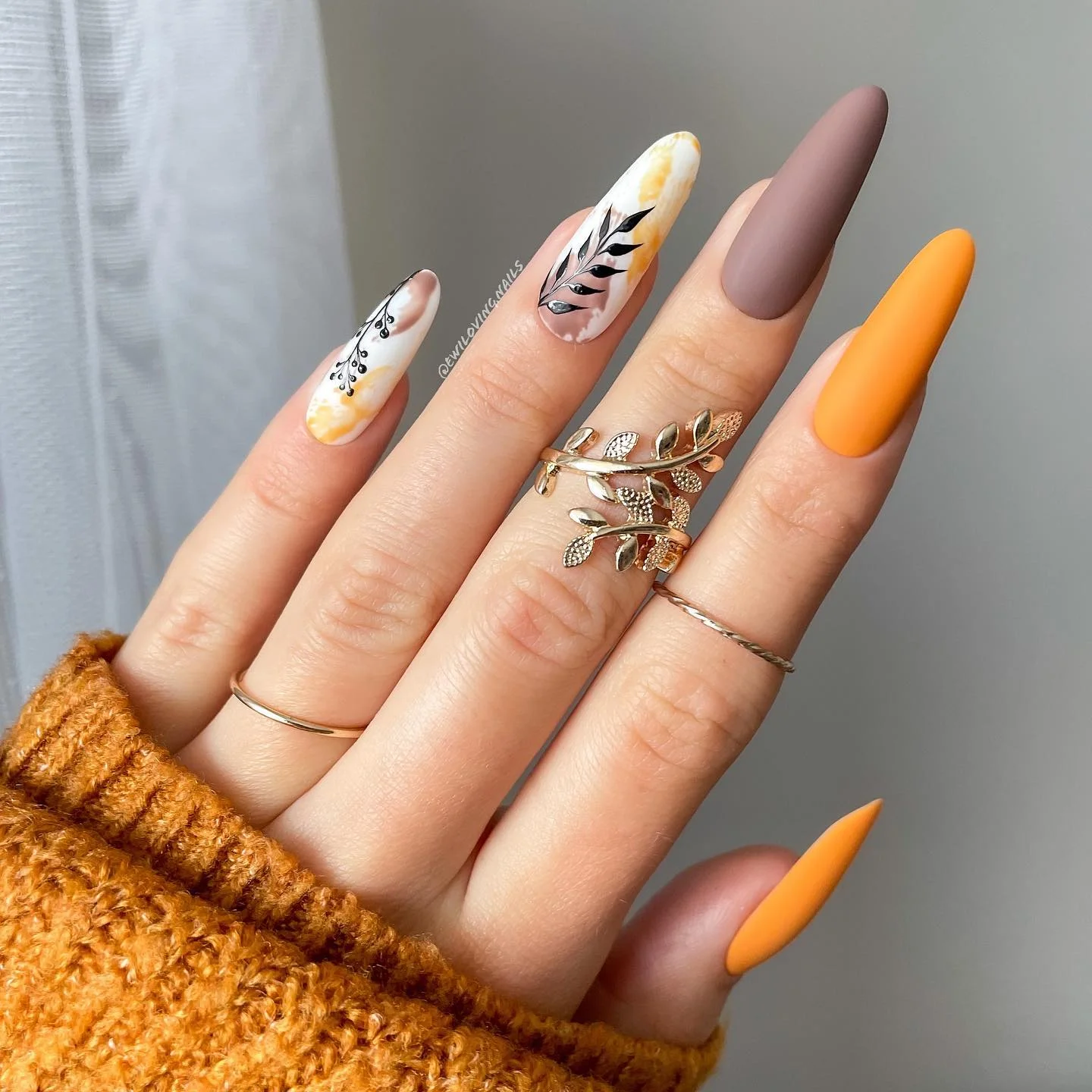 fall nails for pale skin 2026 Warm Amber Almond Nails With Botanical Black Art