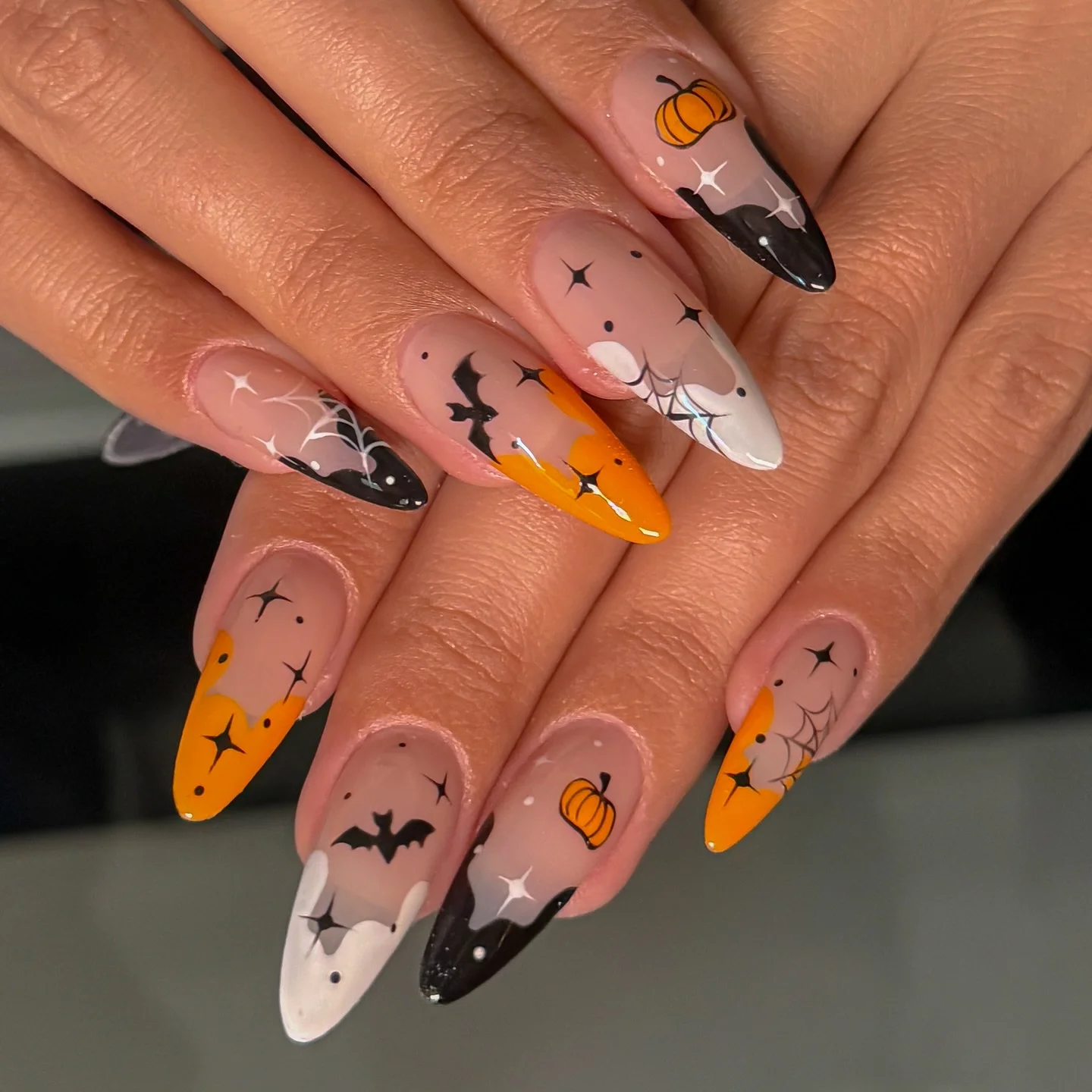 halloween nails designs 2026 Spooky Almond Tips With Pumpkins Bats And Spider Webs