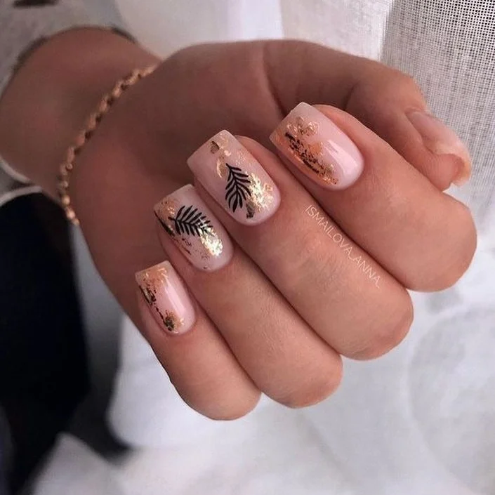 nude fall nails 2026 Blush Nude Nails With Black Leaves And Gold Foil