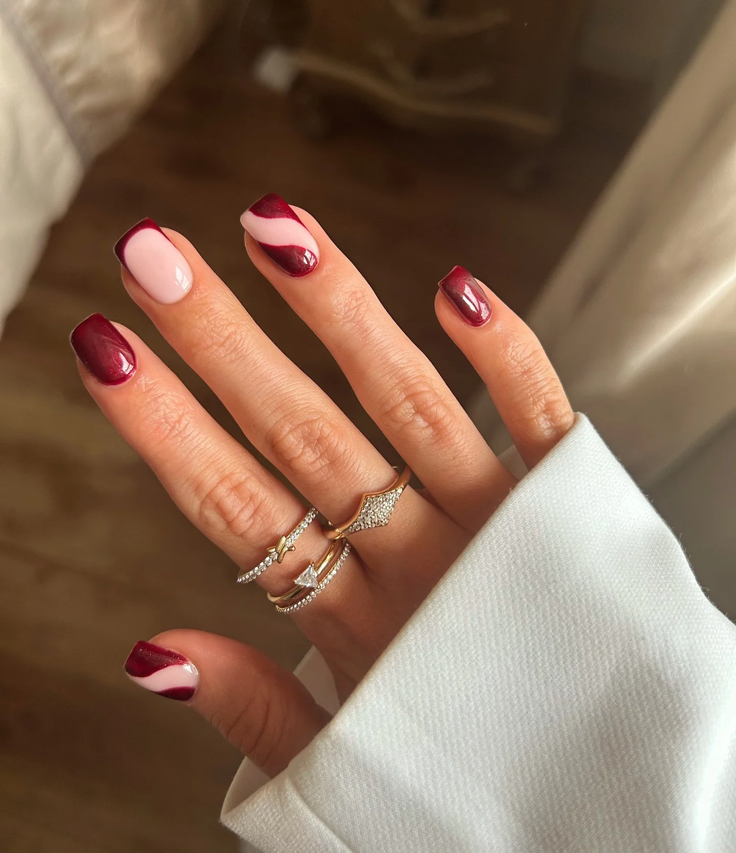 maroon fall nails 2026 Modern Burgundy Waves On Soft Pink Square Nails