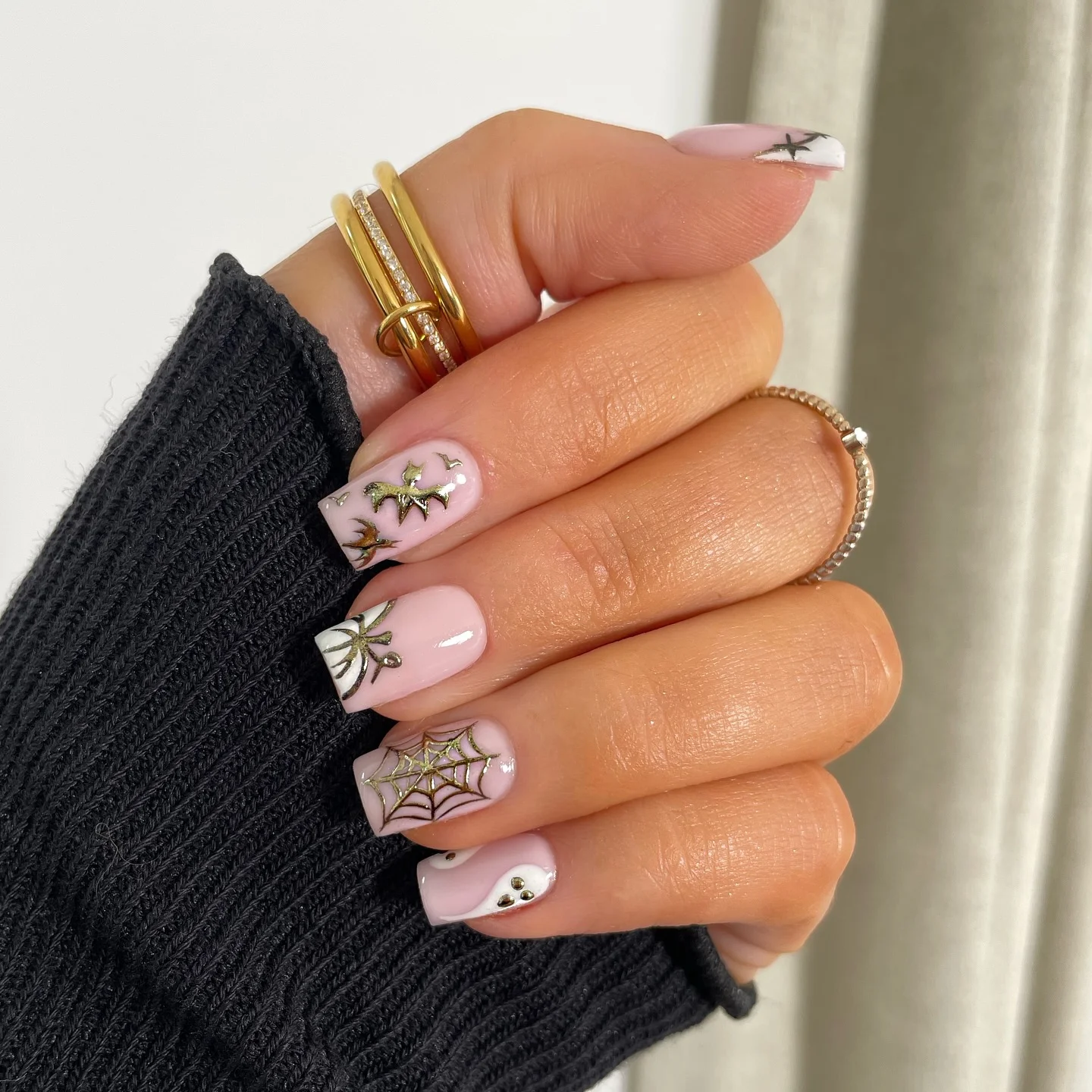 halloween nails designs 2026 Soft Pink Halloween Nails With Golden Spider Web Details