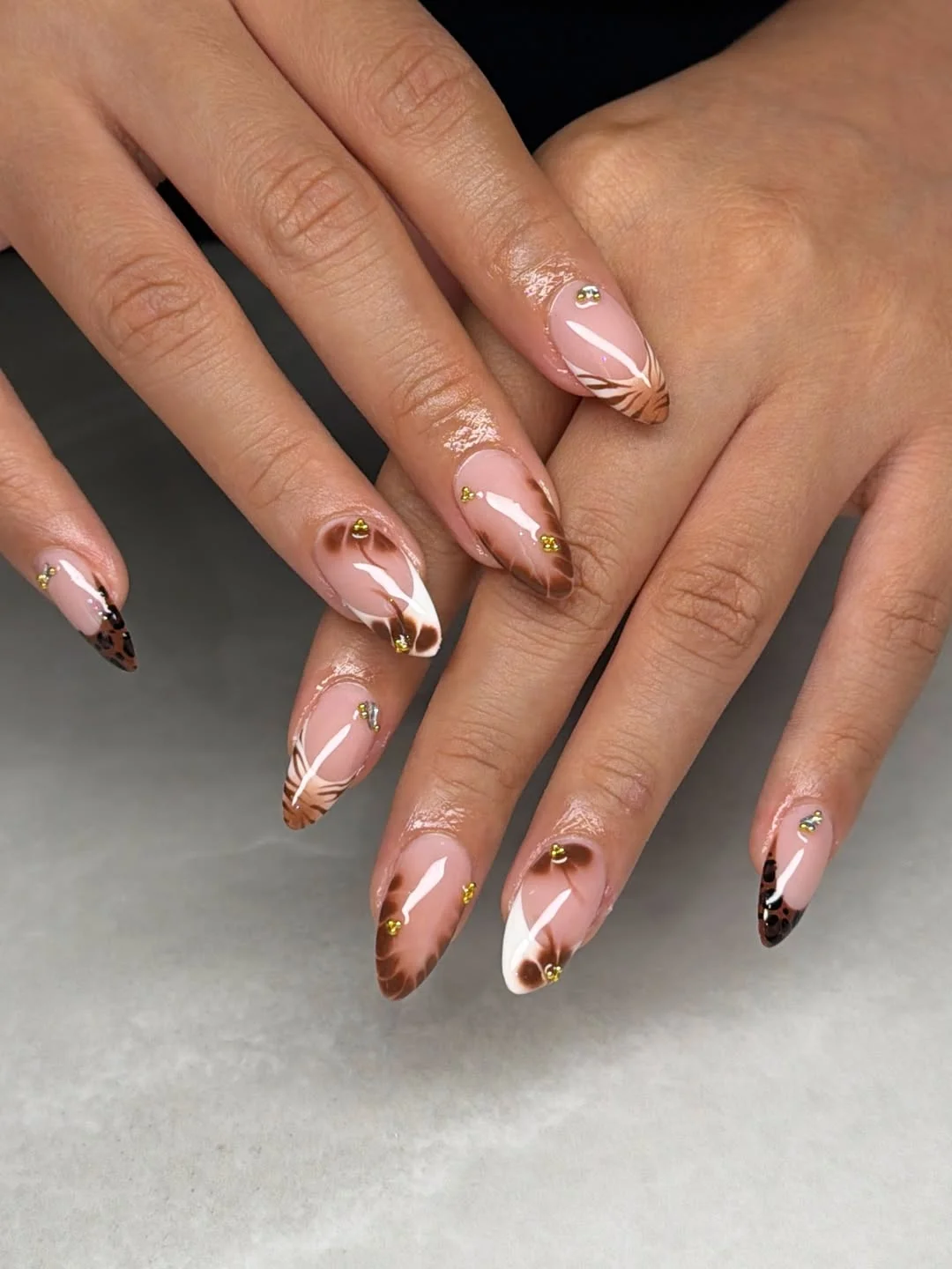 fall gel nails ideas 2026 Elegant Almond Nails With Cocoa Swirls And Gold Studs