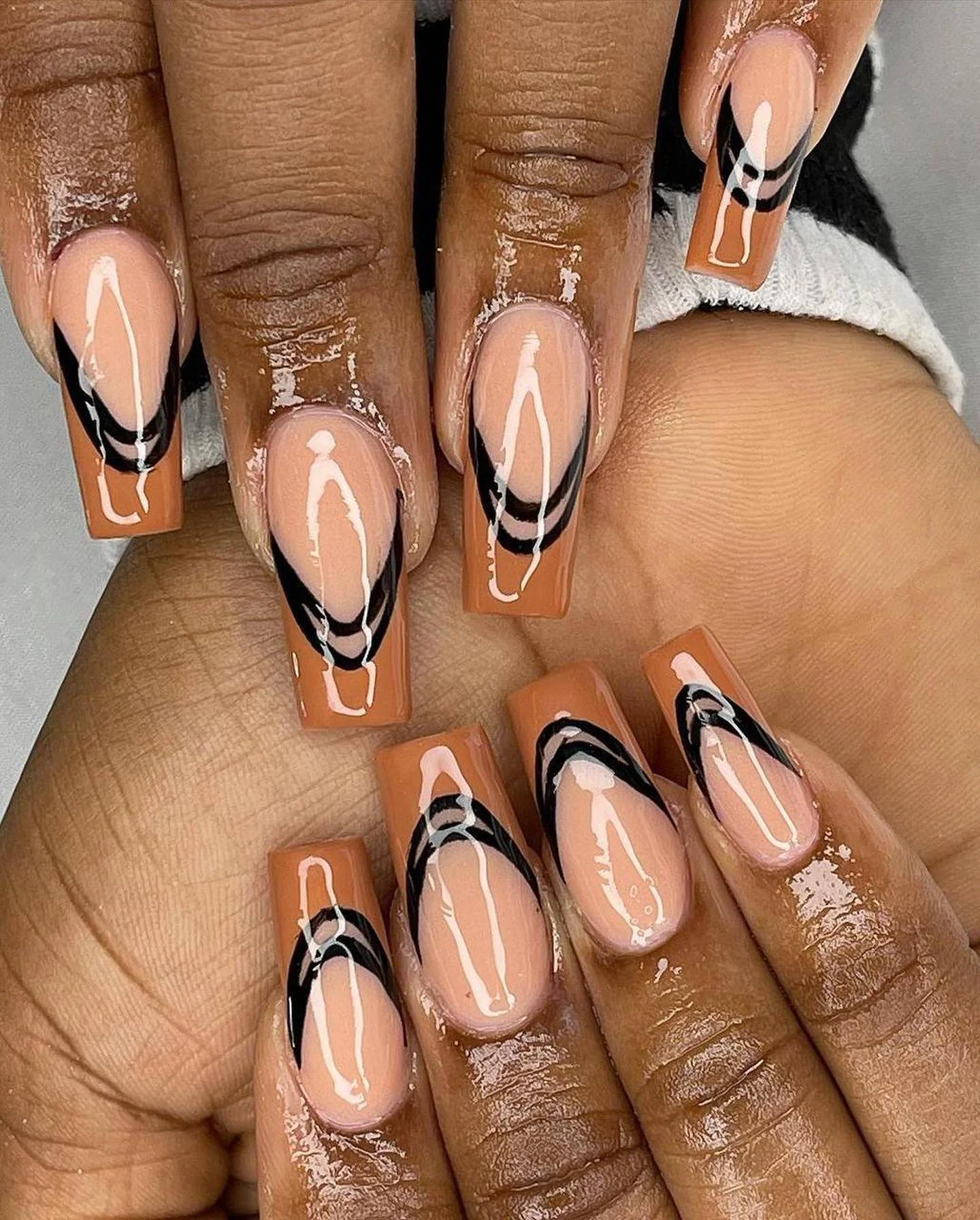 fall nails for dark skin 2026 Abstract Black Swirls On Warm Cinnamon Tips